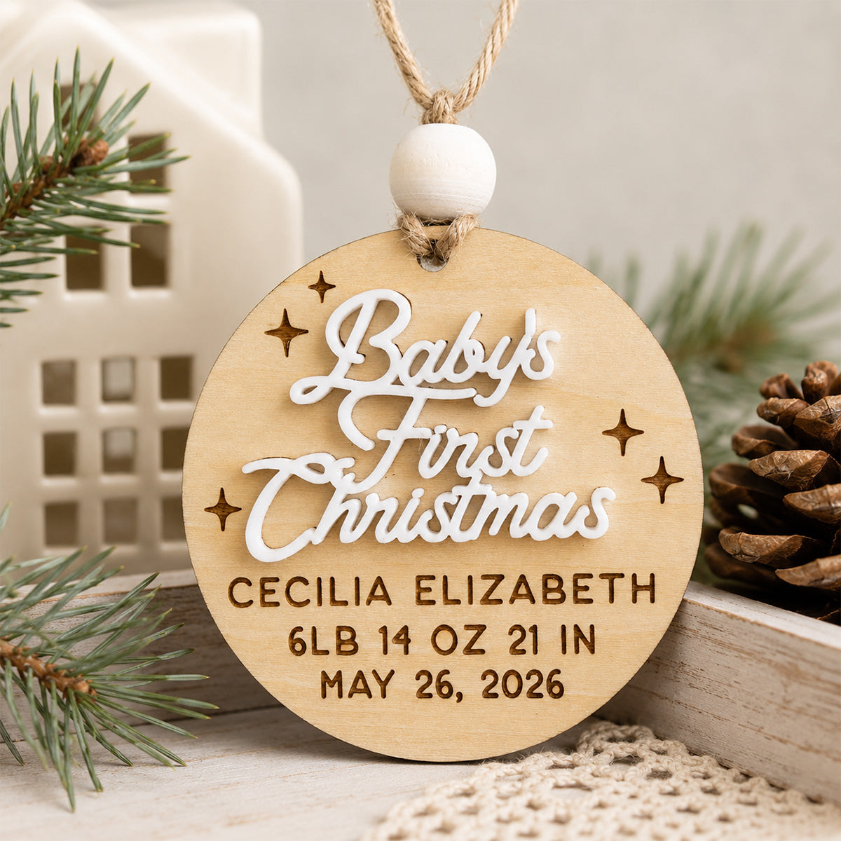 Personalized Baby's First Christmas ornament featuring a custom baby name, birth date, weight, length, and layered script design, handcrafted from Baltic birch.