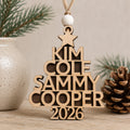 Personalized wooden family tree Christmas ornament featuring custom family names arranged in the shape of a Christmas tree with a personalized year, handcrafted from Baltic birch.