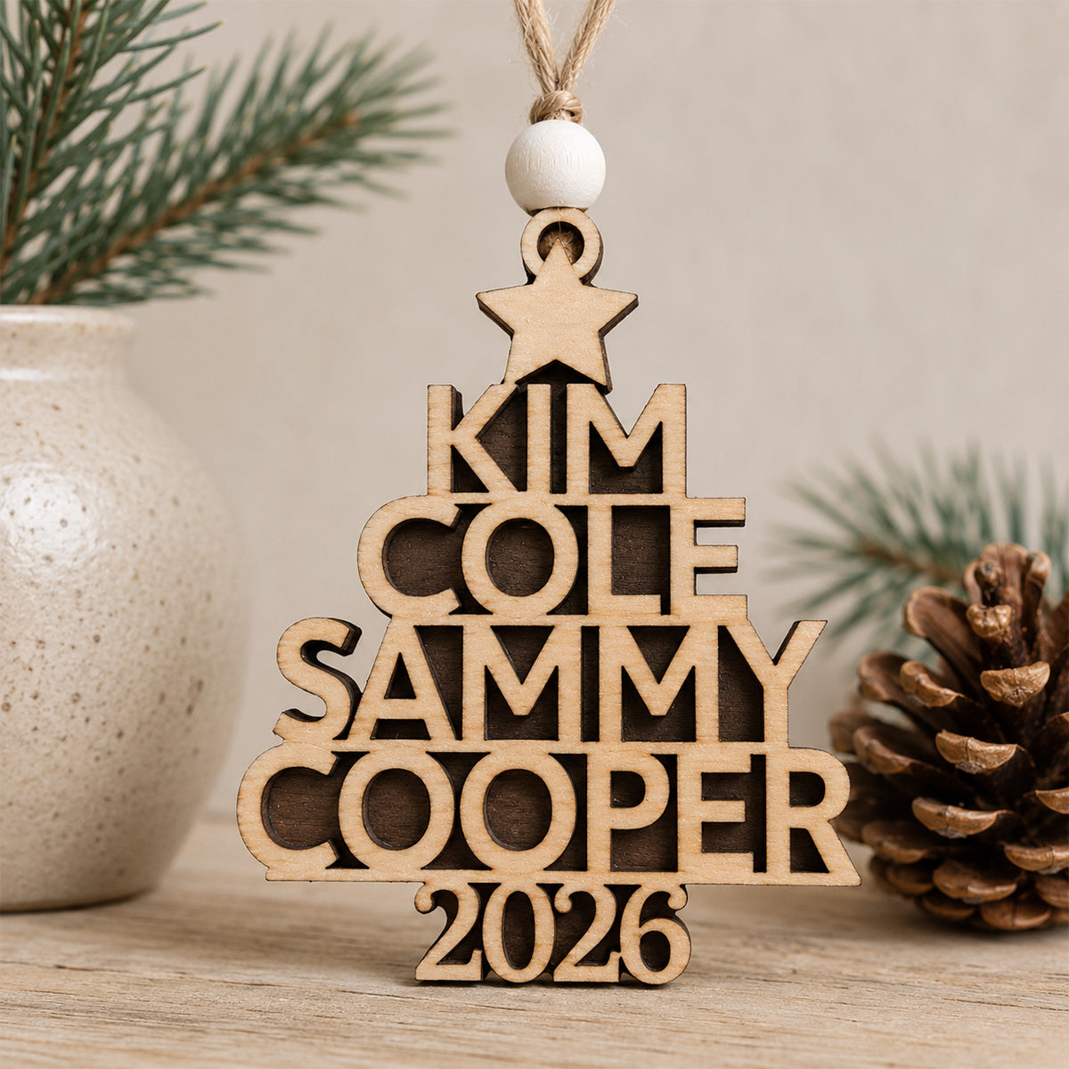 Personalized wooden family tree Christmas ornament featuring custom family names arranged in the shape of a Christmas tree with a personalized year, handcrafted from Baltic birch.